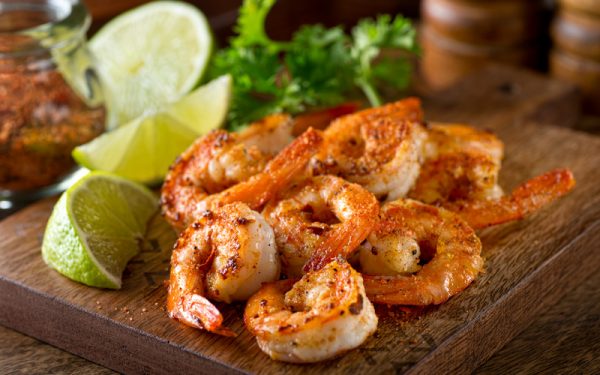 Delicious sauteed shrimp with cajun seasoning and lime on a maple plank.